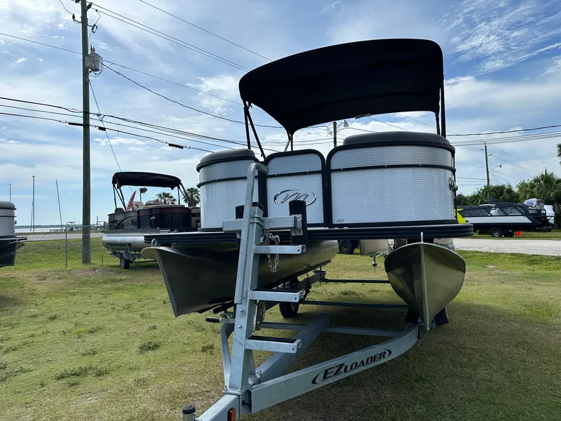 Slide: The Image of 2022 Manitou 18 Aurora pontoon boat on EZ Loader trailer. - 1
