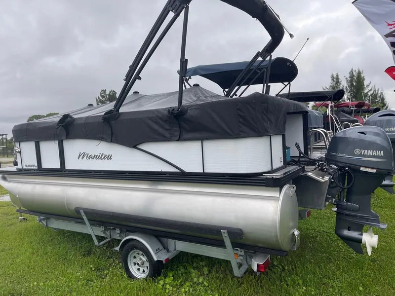 Slide: The Image of 2022 Manitou 18 Aurora pontoon boat with Yamaha outboard motor on trailer. - 10
