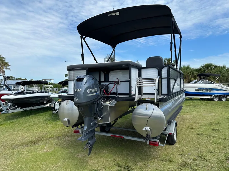 Slide: The Image of 2022 Manitou 18 Aurora pontoon boat with Yamaha 50 HP engine on trailer. - 5