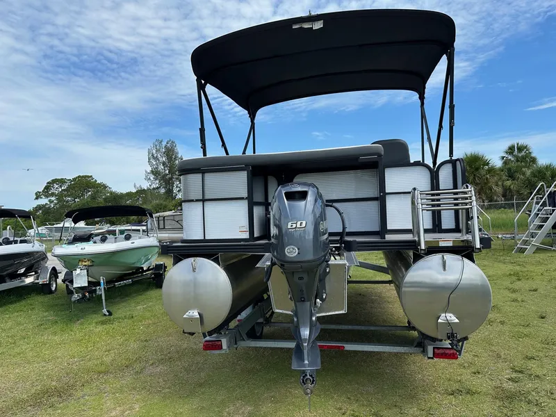 Slide: The Image of 2022 Manitou 18 Aurora pontoon boat with 60 HP engine, rear view. - 6