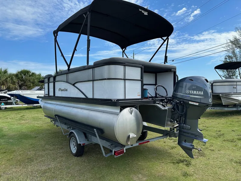 Slide: The Image of 2022 Manitou 18 Aurora pontoon boat with Yamaha outboard motor on trailer. - 7