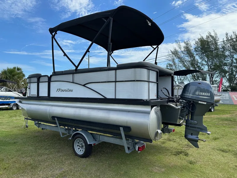 Slide: The Image of 2022 Manitou 18 Aurora pontoon boat with Yamaha outboard motor on trailer. - 8