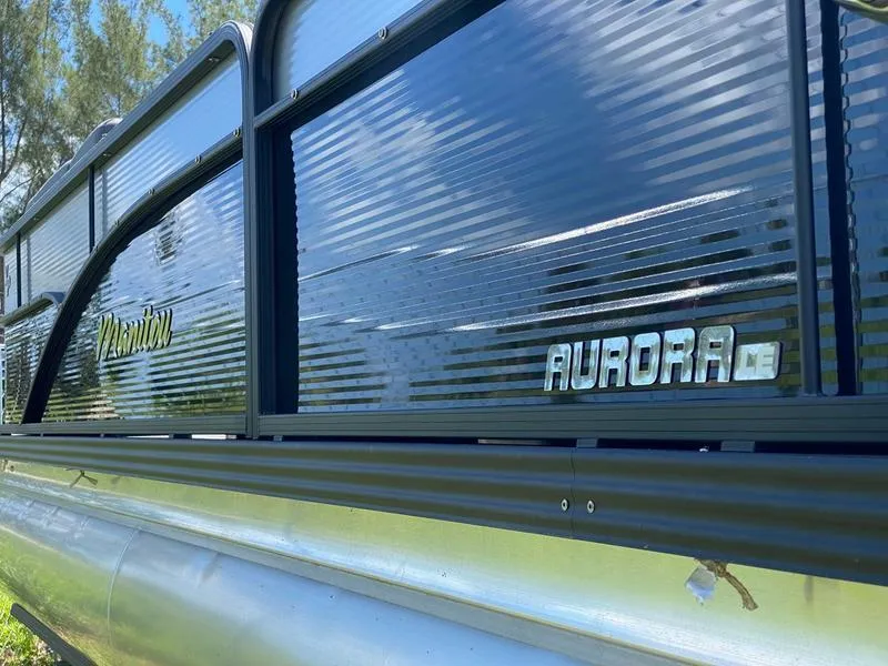 Slide: The Image of 2021 Manitou 21 AURORA LE RF VP pontoon boat side view. - 12