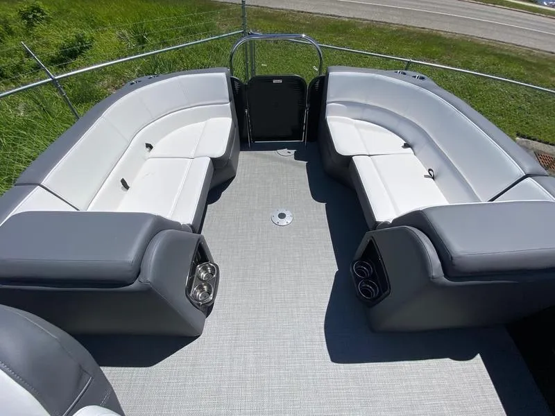 Slide: The Image of 2021 Manitou 21 AURORA LE RF VP boat interior with spacious seating and cup holders. - 19