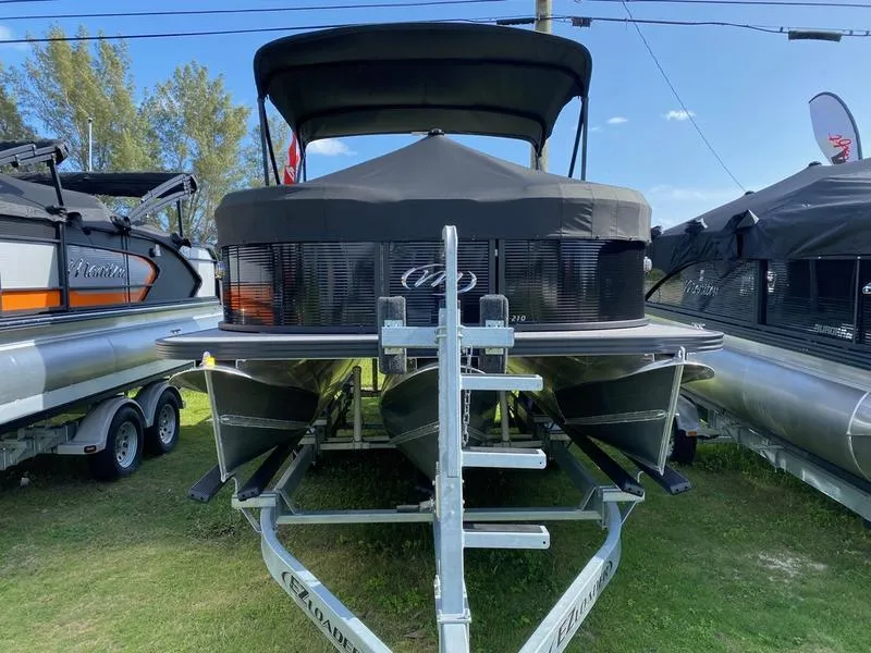 Slide: The Image of 2021 Manitou 21 AURORA LE RF VP pontoon boat on a trailer. - 2