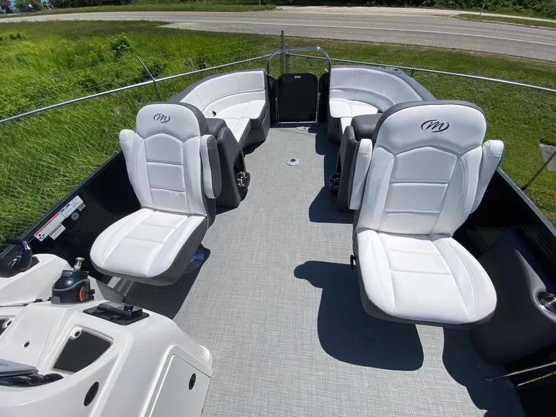 Slide: The Image of 2021 Manitou 21 AURORA LE RF VP boat interior with white seating. - 20