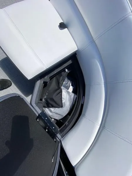 Slide: The Image of 2021 Manitou 21 AURORA LE RF VP boat with open storage compartment under seat. - 22