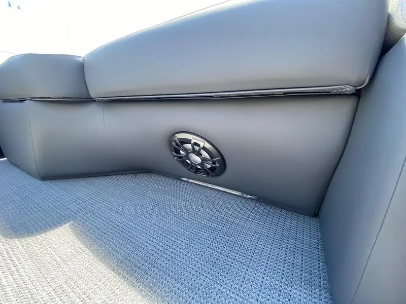 Slide: The Image of 2021 Manitou 21 AURORA LE RF VP boat interior with speaker and cushioned seating. - 24