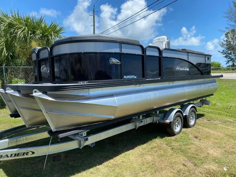 Slide: The Image of 2021 Manitou 21 AURORA LE RF VP pontoon boat on a trailer. - 3