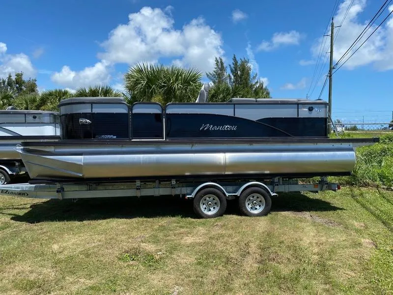 Slide: The Image of 2021 Manitou 21 AURORA LE RF VP pontoon boat on a trailer, side view. - 5