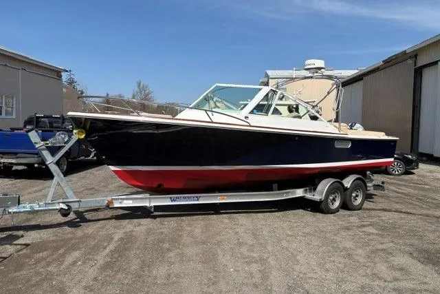 The Image of 2006 Hunt Yachts Harrier 25 on trailer, parked outdoors, showcasing sleek design and classic styling. - 0
