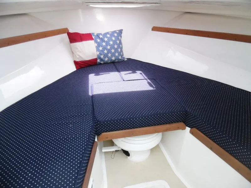 Slide: The Image of Interior of 2006 Hunt Yachts Harrier 25 with cushioned sleeping area. - 10
