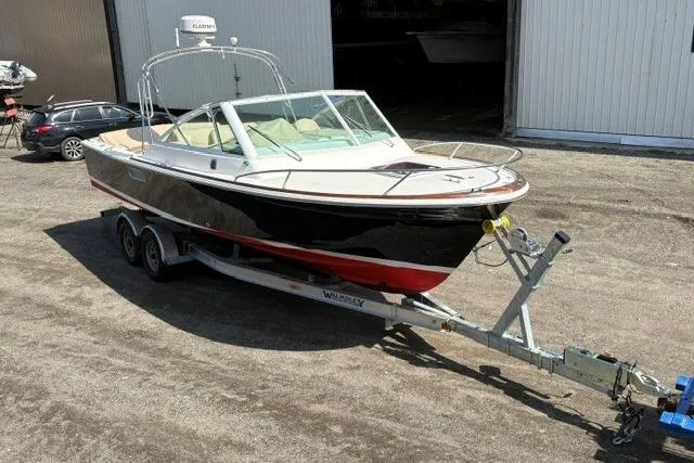 Slide: The Image of 2006 Hunt Yachts Harrier 25 on trailer, parked outdoors near a building. - 2