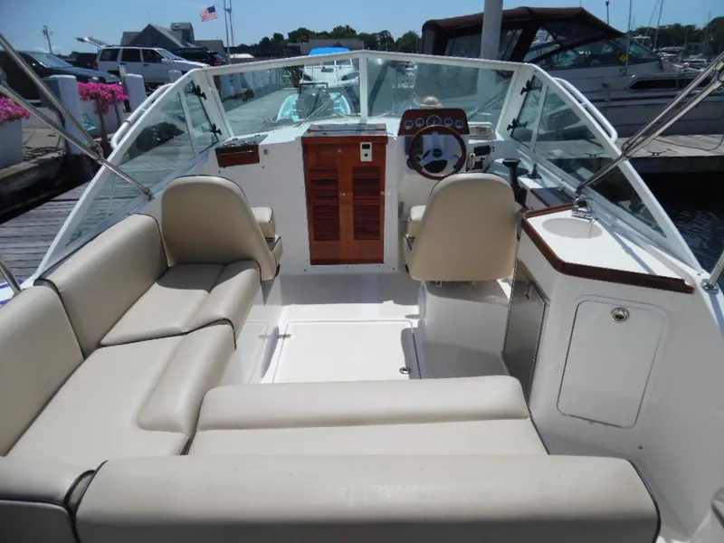 Slide: The Image of Interior of a 2006 Hunt Yachts Harrier 25 with beige seating and helm console. - 4