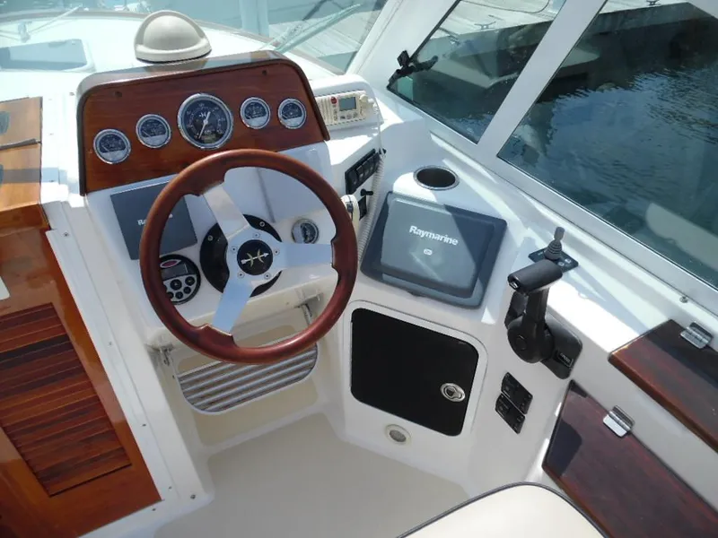 Slide: The Image of 2006 Hunt Yachts Harrier 25 cockpit with wooden steering wheel and instruments. - 7