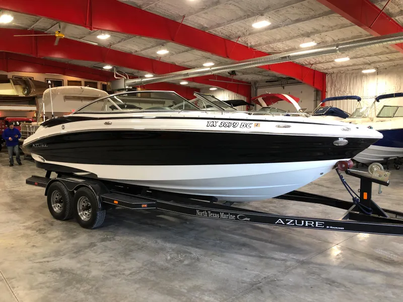 Slide: The Image of 2010 Azure 258 boat on trailer in indoor showroom. - 1