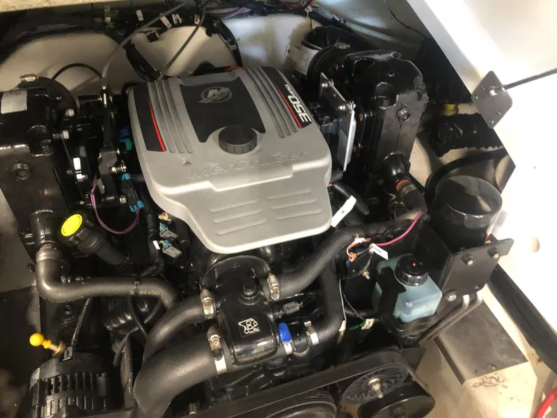 Slide: The Image of Engine compartment of a 2010 Azure 258 boat, featuring a well-maintained motor. - 12