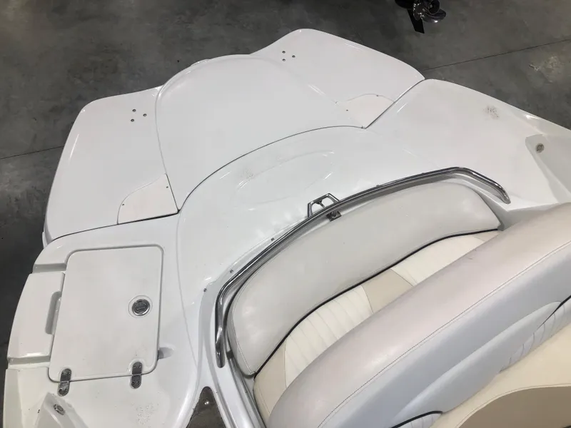 Slide: The Image of White Azure 258 boat interior, 2010 model, featuring sleek seating and storage compartments. - 6