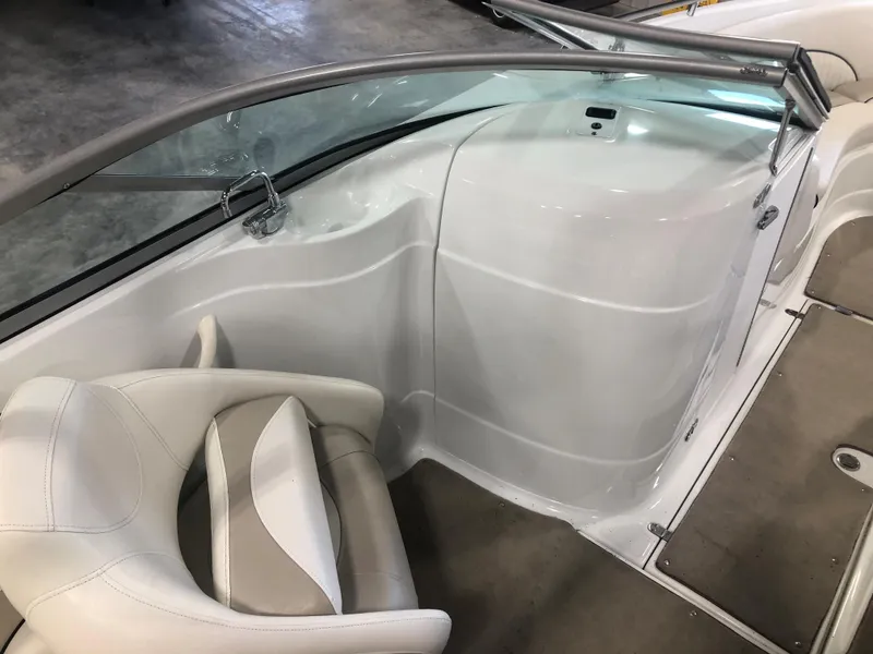 Slide: The Image of Interior of a 2010 Azure 258 boat, featuring white seating and sleek design. - 7