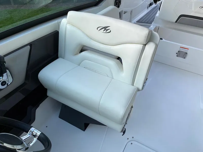 Slide: The Image of 2015 Monterey 288 Super Sport boat interior with white leather seating and steering wheel. - 5