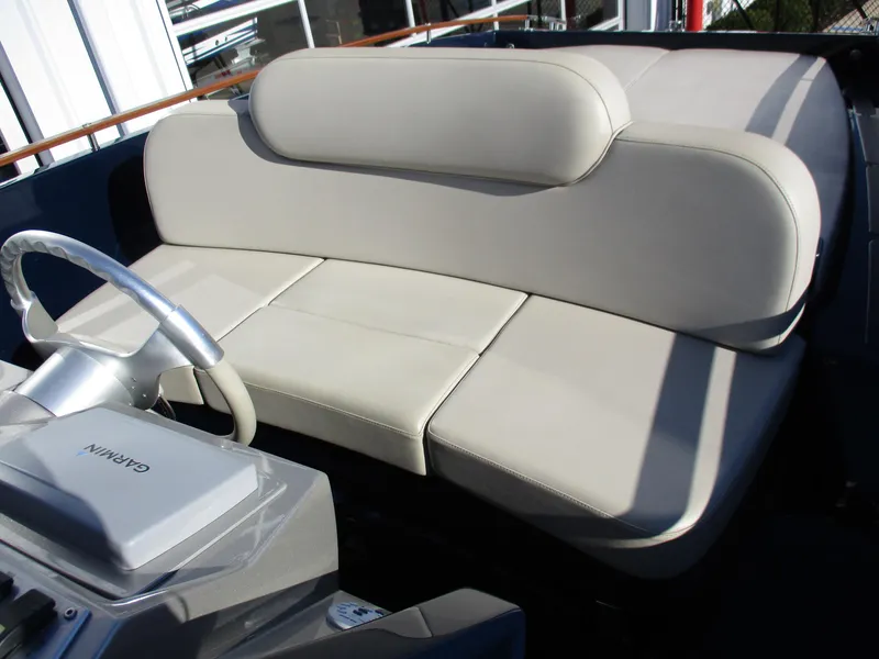 Slide: The Image of 2005 Riva 33 SUNRIVA boat interior with beige leather seating and steering wheel. - 13