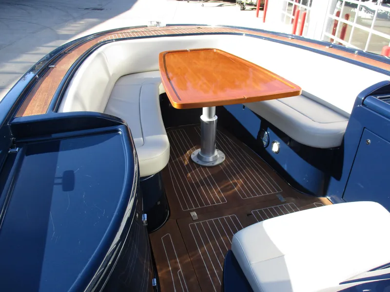 Slide: The Image of 2005 Riva 33 SUNRIVA boat interior with wooden table and cushioned seating. - 15