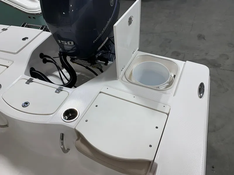 Slide: The Image of 2024 Robalo 206 Cayman boat stern with Yamaha 150 engine and storage compartments. - 13