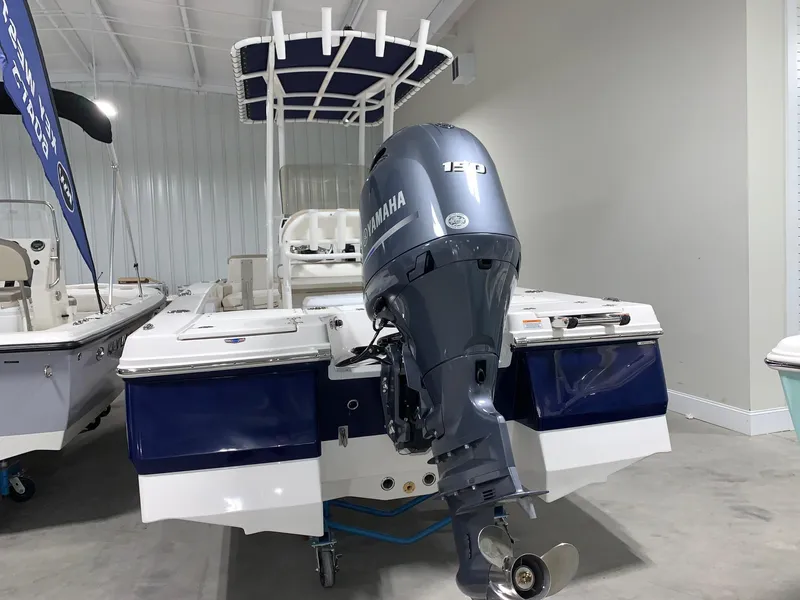 Slide: The Image of 2024 Robalo 206 Cayman boat with Yamaha 150 outboard motor in showroom. - 2
