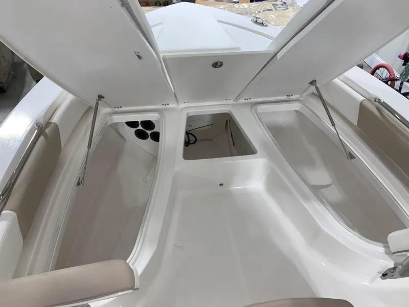 Slide: The Image of 2024 Robalo 206 Cayman boat storage compartments open. - 5