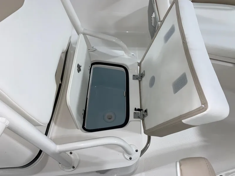 Slide: The Image of 2024 Robalo 206 Cayman boat storage compartment with open lid. - 7