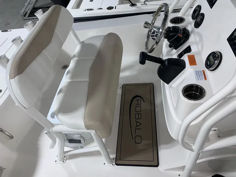 Slide: The Image of 2024 Robalo 206 Cayman boat interior with steering console and cushioned seating. - 9