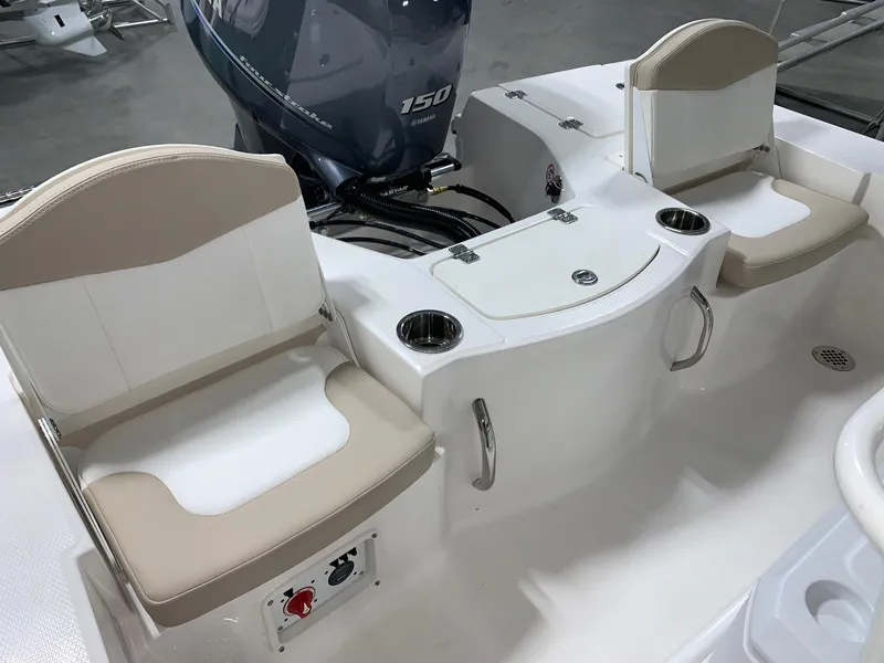 Slide: The Image of 2024 Robalo 206 Cayman boat interior with seating and Yamaha 150 outboard motor. - 11