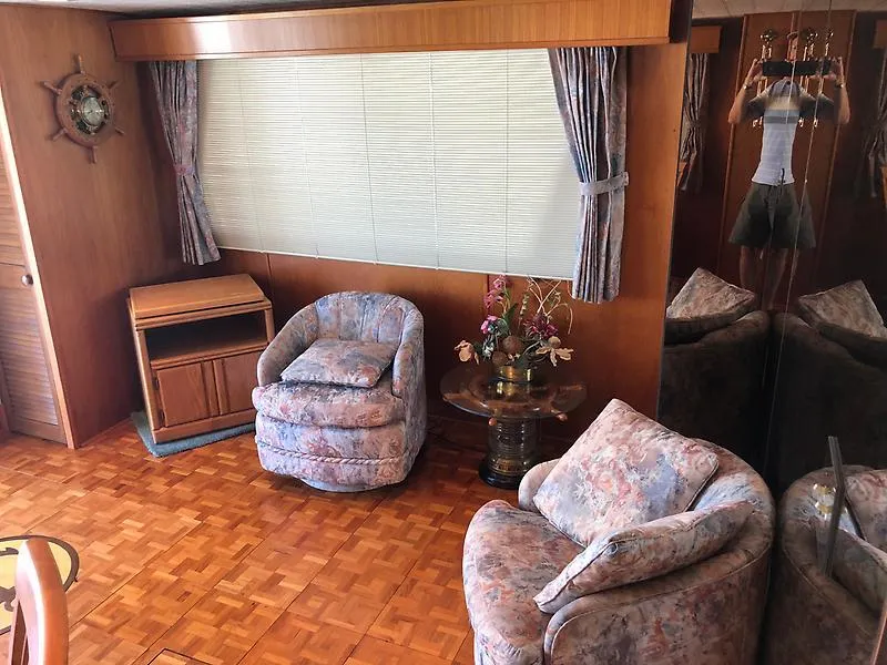 Slide: The Image of Interior of 1989 Pluckebaum 75 Coastal Cruiser with cozy seating and wooden decor. - 11