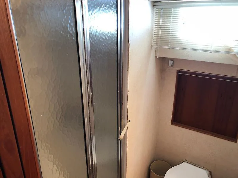 Slide: The Image of Bathroom interior of a 1989 Pluckebaum 75 Coastal Cruiser with shower and toilet. - 12