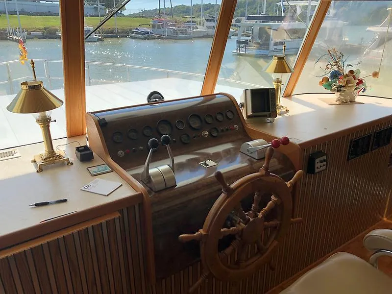 Slide: The Image of Helm of 1989 Pluckebaum 75 Coastal Cruiser with wooden steering wheel and control panel. - 16