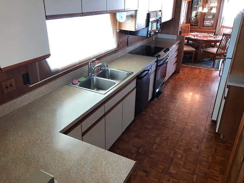 Slide: The Image of Spacious kitchen in 1989 Pluckebaum 75 Coastal Cruiser with modern appliances and dining area. - 22