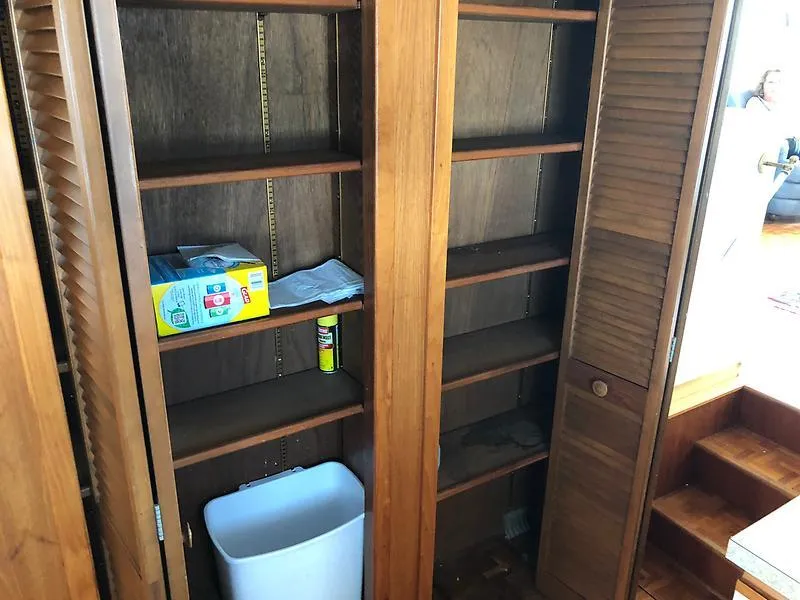 Slide: The Image of Wooden storage shelves inside 1989 Pluckebaum 75 Coastal Cruiser yacht. - 23