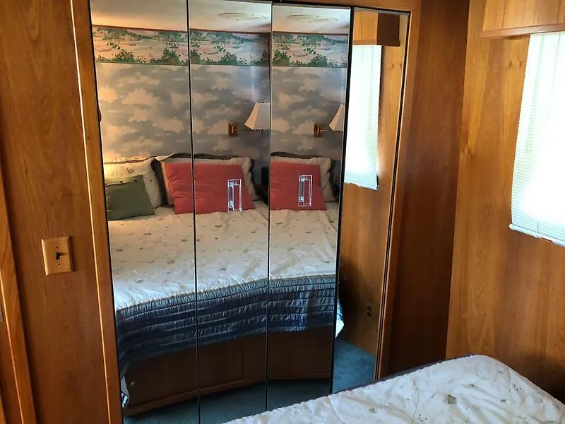 Slide: The Image of Bedroom interior of 1989 Pluckebaum 75 Coastal Cruiser with mirrored closet doors. - 24