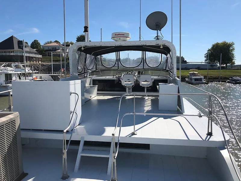 Slide: The Image of 1989 Pluckebaum 75 Coastal Cruiser upper deck with helm station and seating. - 4