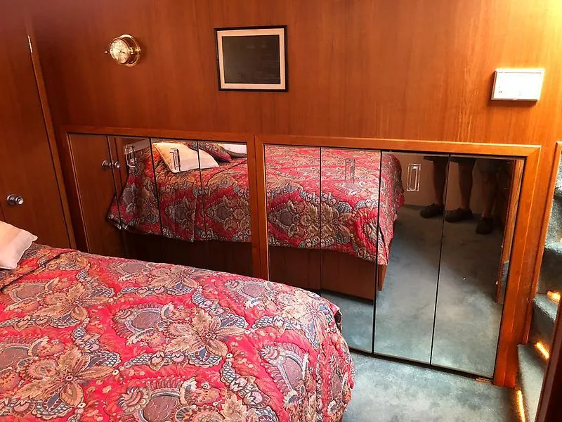 Slide: The Image of Bedroom interior of 1989 Pluckebaum 75 Coastal Cruiser with mirrored closet and patterned bedspread. - 5