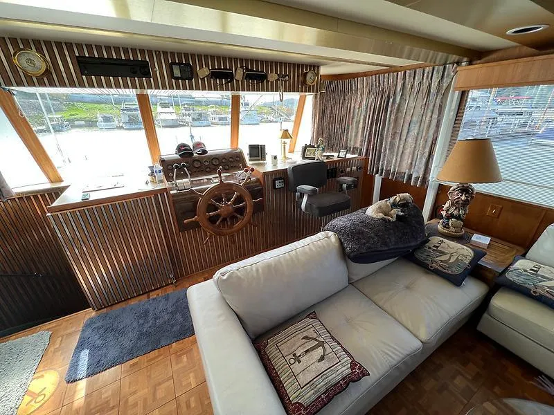 Slide: The Image of Interior of 1989 Pluckebaum 75 Coastal Cruiser with helm, sofa, and nautical decor. - 8