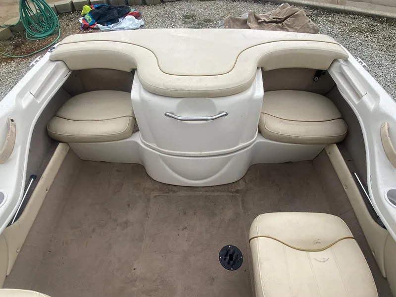 Slide: The Image of 2000 Sea Ray 180BR boat interior with beige seating and storage compartments. - 12