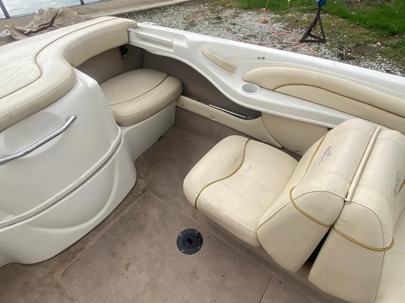 Slide: The Image of Interior of a 2000 Sea Ray 180BR boat with beige seating and carpet. - 14