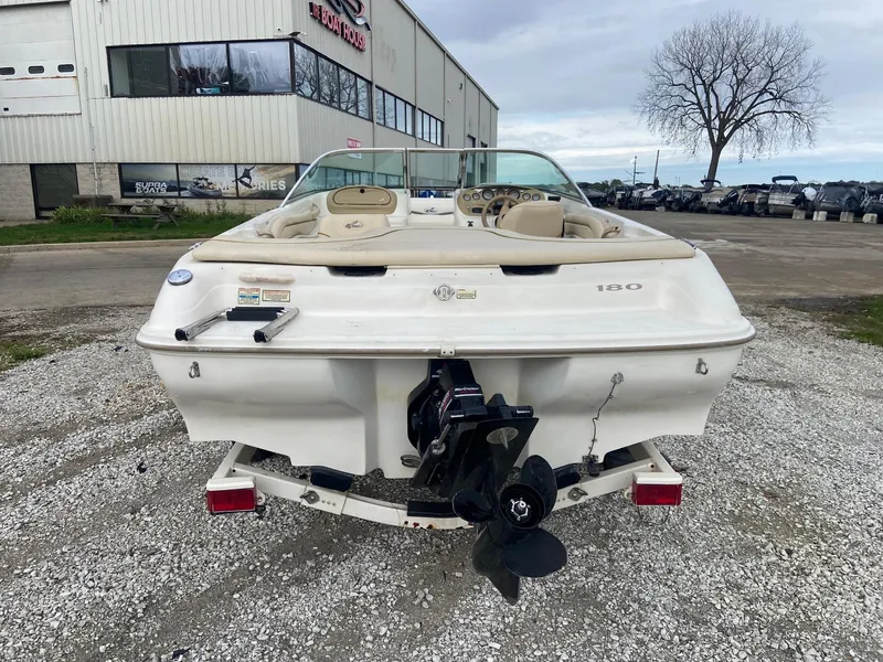 Slide: The Image of 2000 Sea Ray 180BR boat rear view at a dealership. - 6