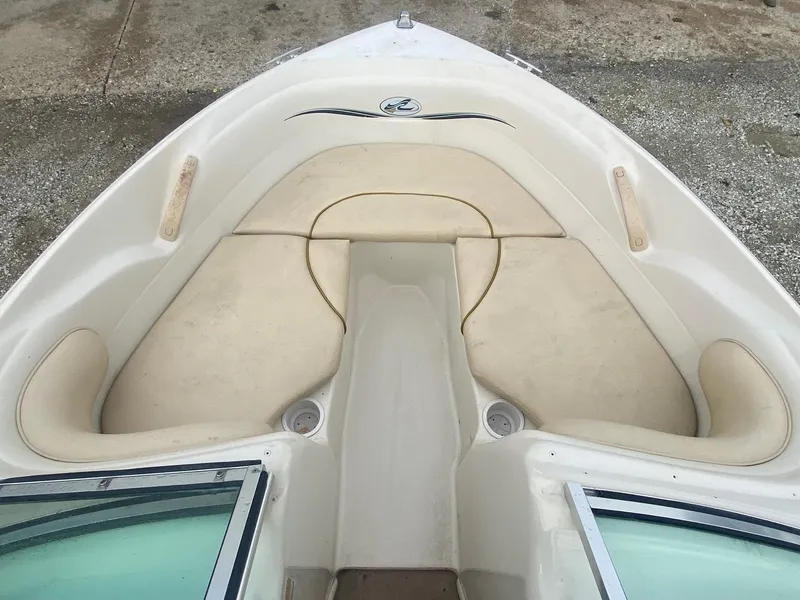 Slide: The Image of Bow seating area of a 2000 Sea Ray 180BR boat with beige cushions. - 8
