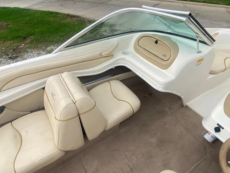 Slide: The Image of Interior of a 2000 Sea Ray 180BR boat with beige seating and dashboard. - 9