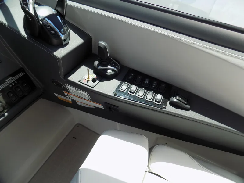 Slide: The Image of Control panel of 2022 Regal 33 XO boat with switches and joystick. - 10