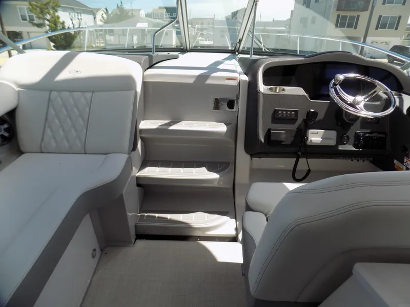 Slide: The Image of 2022 Regal 33 XO boat interior with helm, seating, and steps. - 11