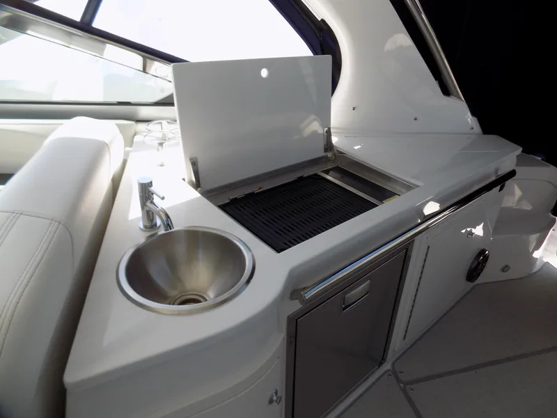 Slide: The Image of 2022 Regal 33 XO yacht kitchenette with sink and grill. - 13