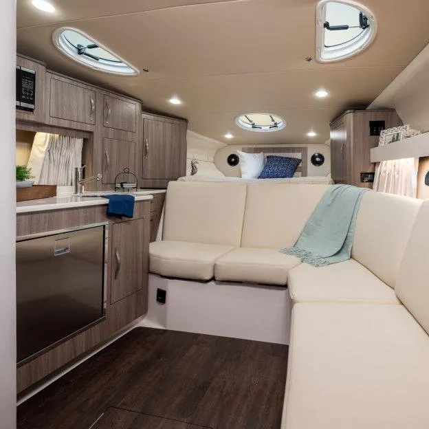 Slide: The Image of Luxurious interior of 2022 Regal 33 XO yacht with modern kitchen and cozy seating area. - 14